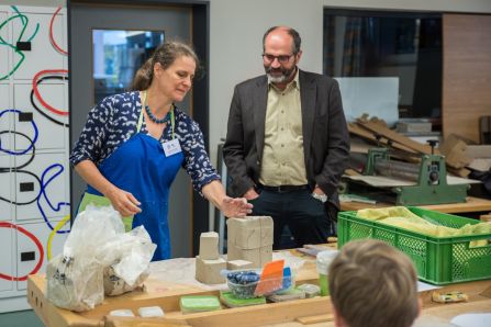 Keramikmeisterin Katharina Heusinger erklärt Schulleiter Dr. Balk die Vorgehensweise beim Erstellen von Keramik.